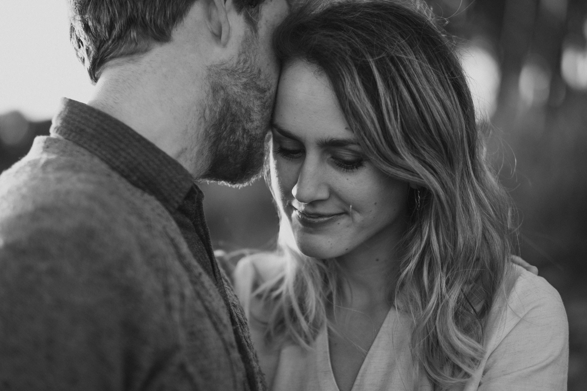 a close up on a recently engaged couple in black and white