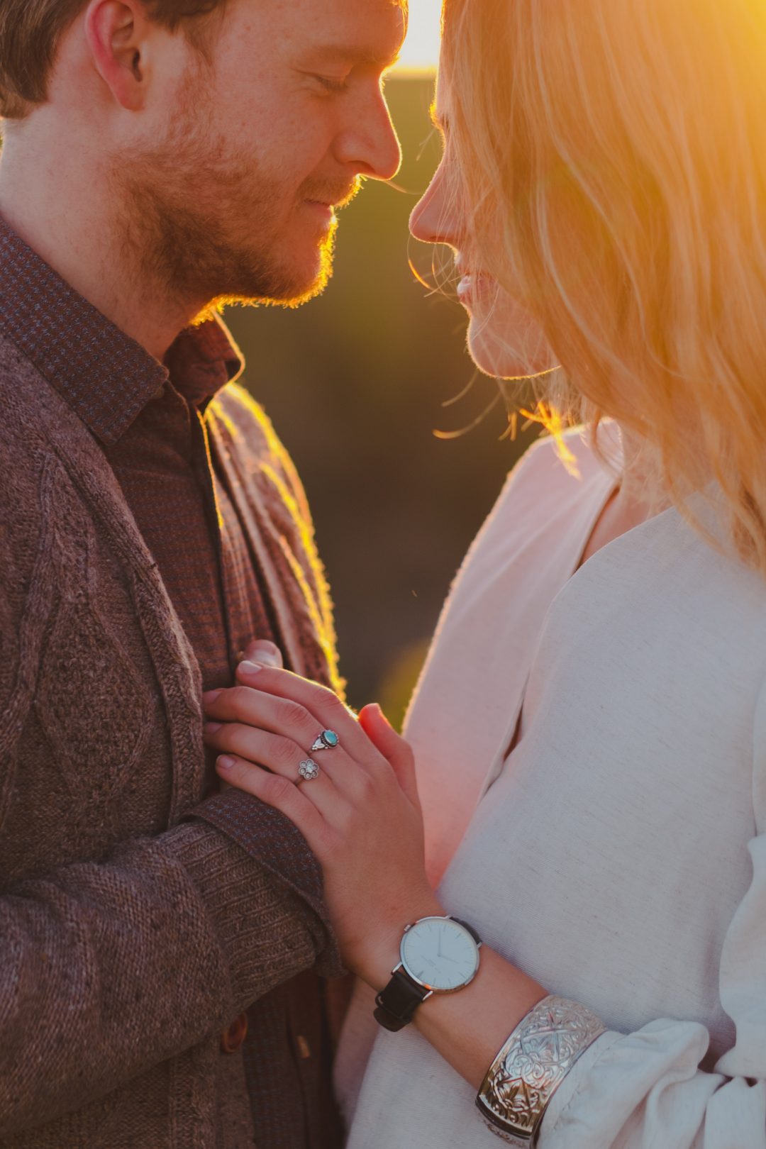 a newly engaged couple at sunset