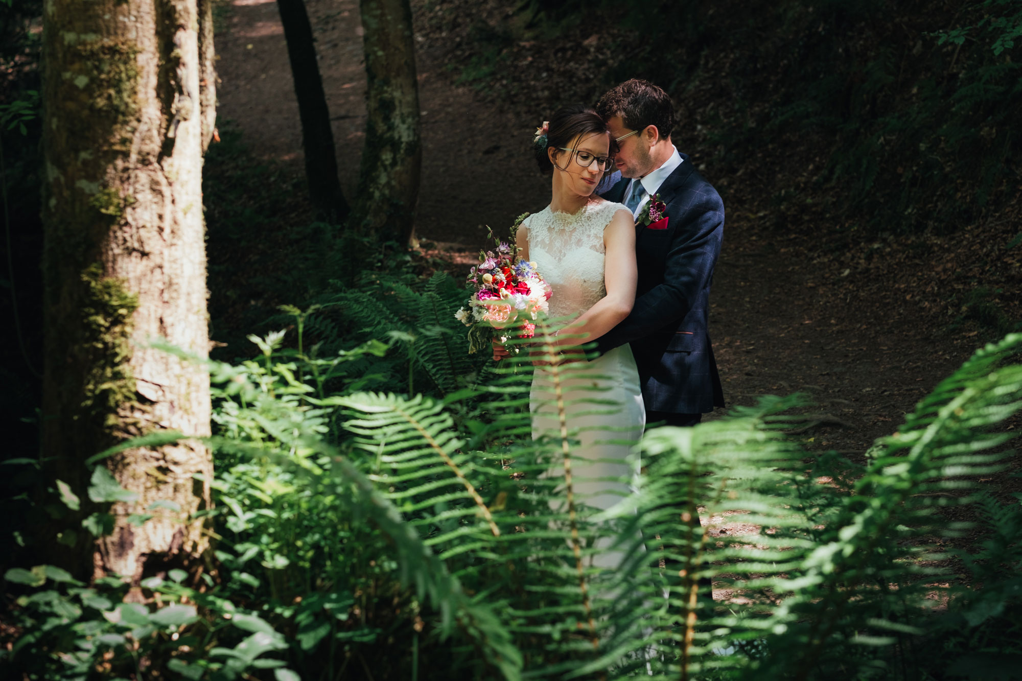newly married couple in the woods at their festival wedding