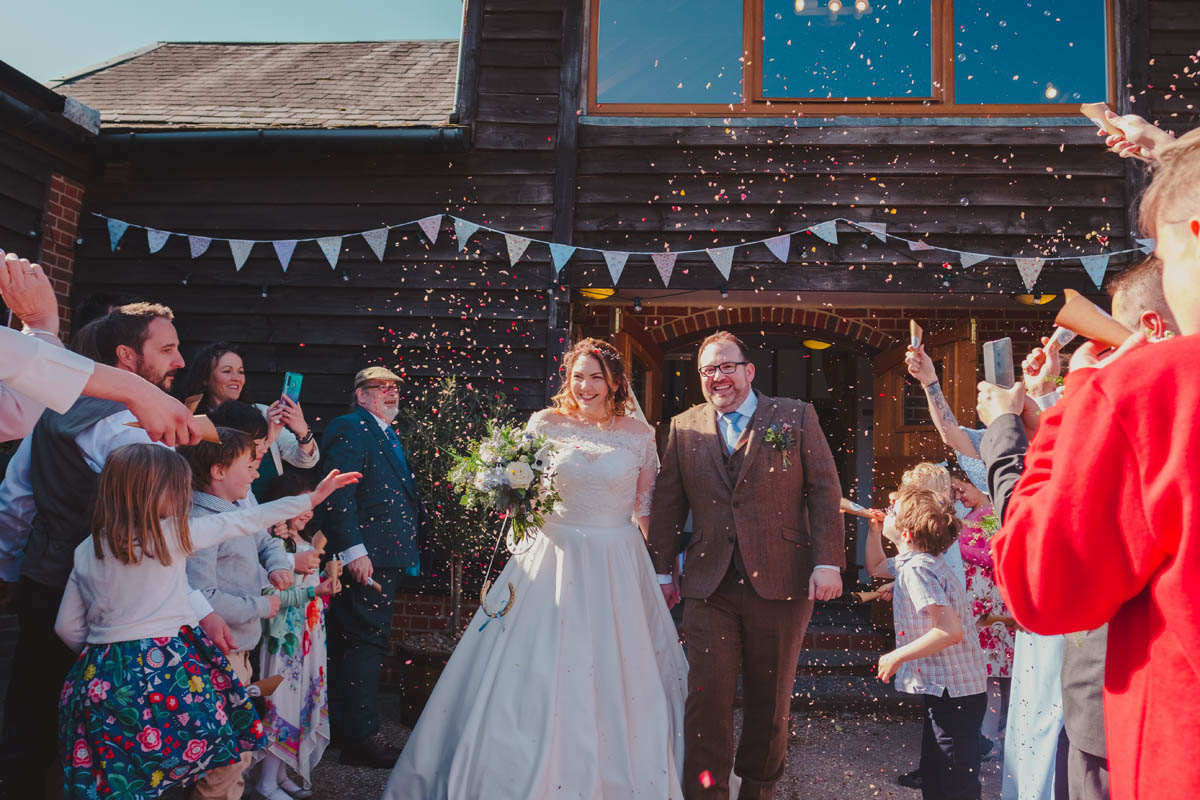 confetti being thrown at a barn wedding
