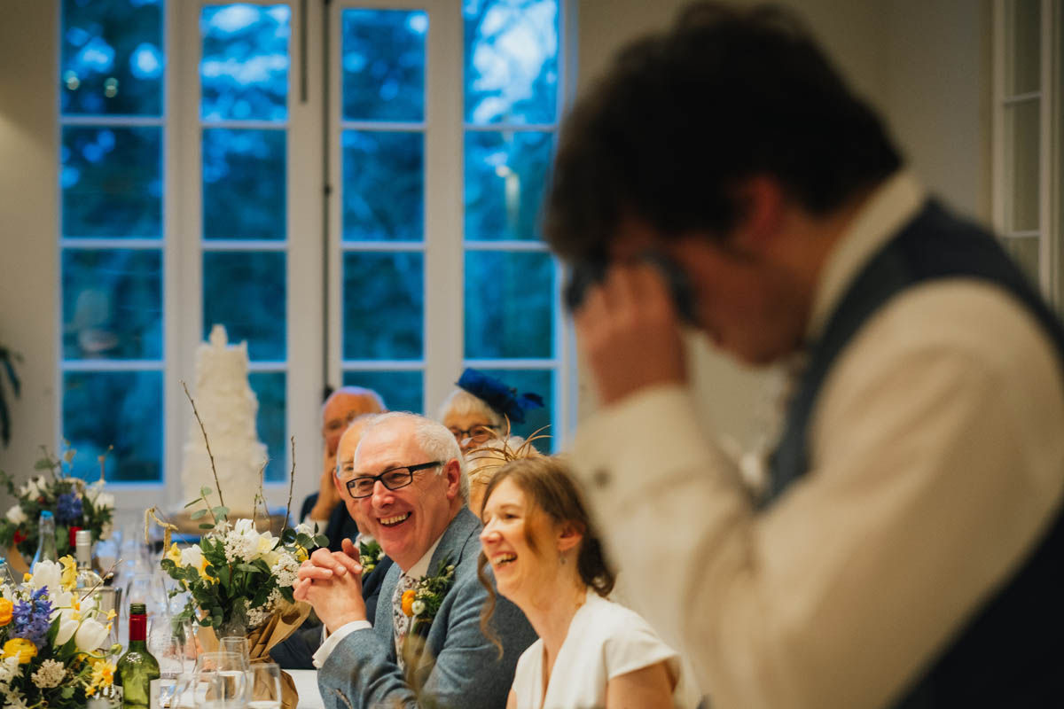 groom laughing at his son who is crying
