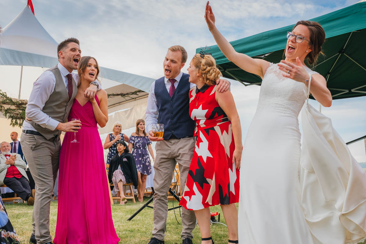 bride sings with her wedding guests