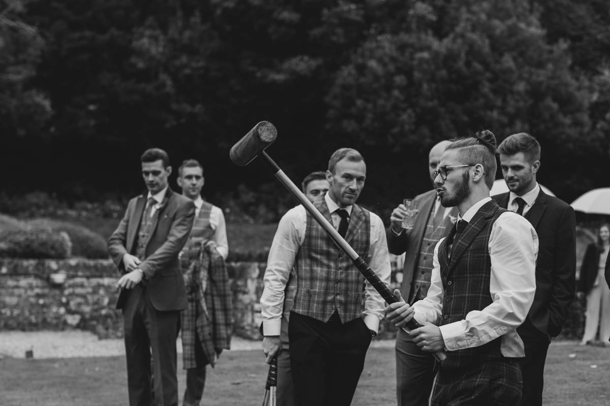 boys play crochet on the lawn