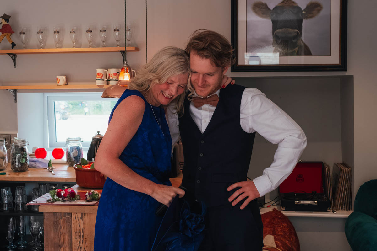 groom and his mum share a meaningful embrace