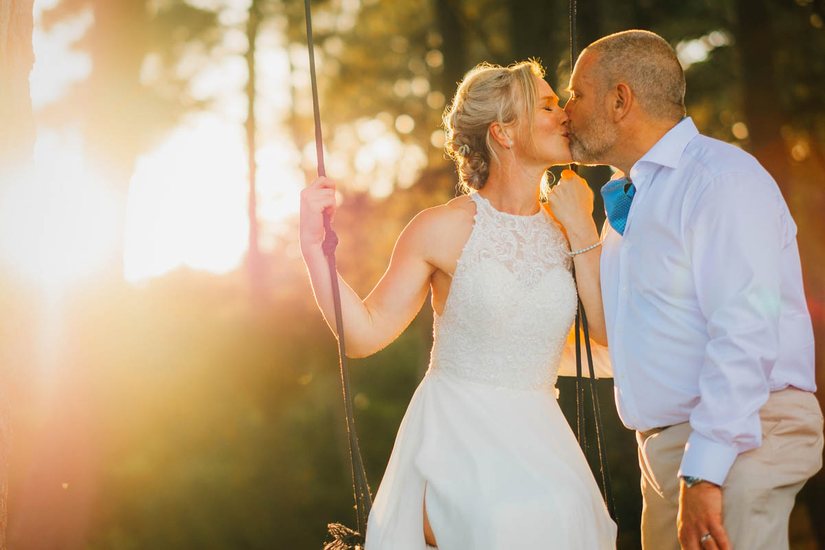 bride and groom kissing at golden hour