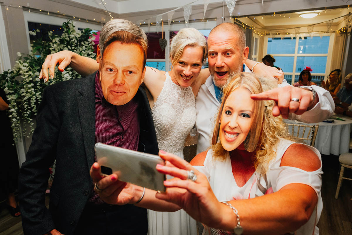 the just married couple take a selfie with guests