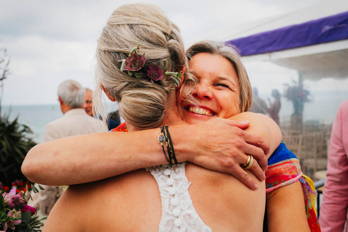 a wedding guests hugs the bride to congratulate her