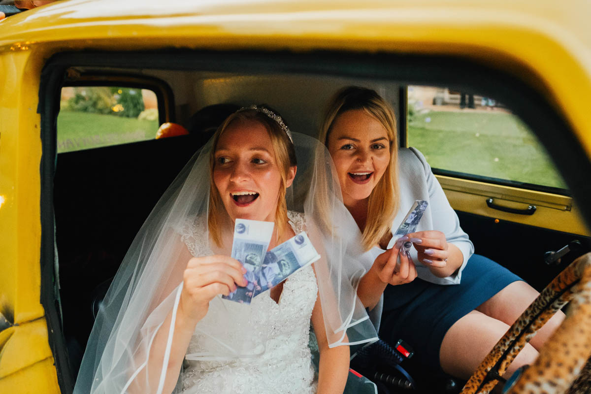 bride and a wedding guest in a car outside Coombe lodge