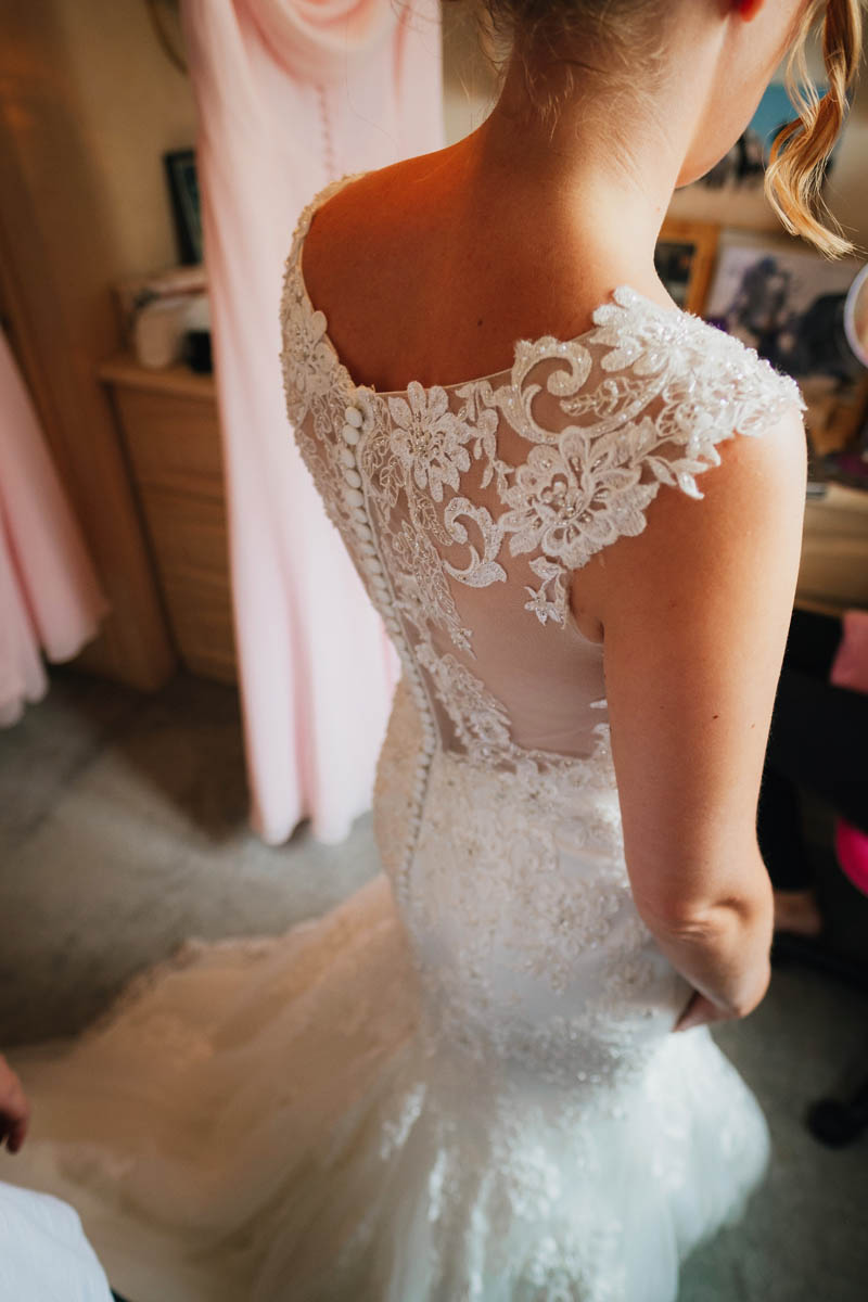 detailed photo of the back of the bride's dress
