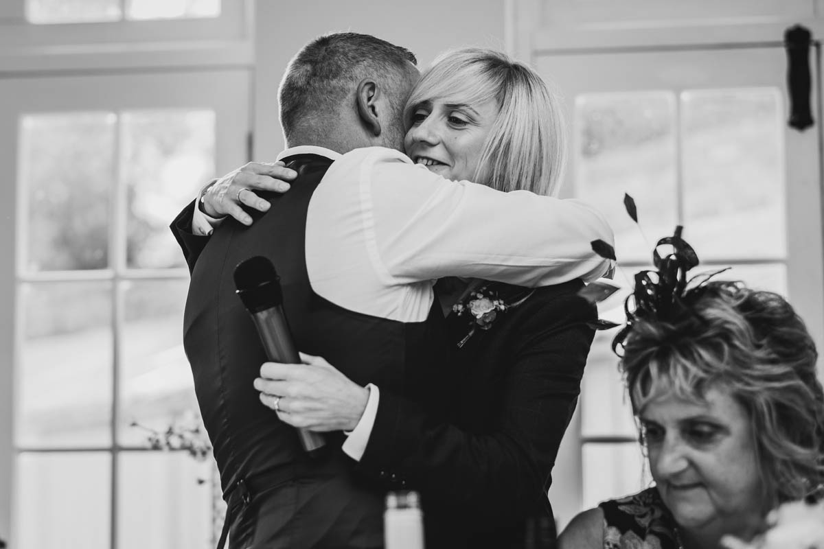 black and white photograph of the bride hugging her father
