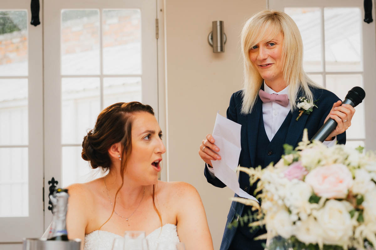 the bride looks horrified as her new wife gives a speech