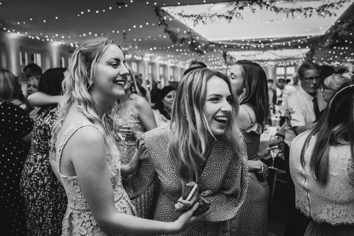 friend's laughing as they dance on the dance floor at Elmhay Park wedding venue