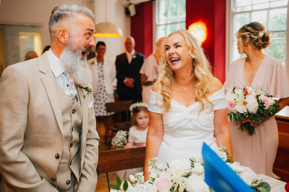 bride and groom look delighted to see one another at their Bristol wedding ceremony