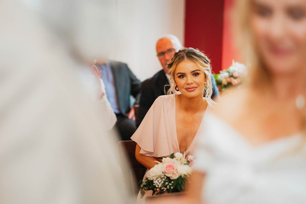 bride's daughter smiles as her mum gets married