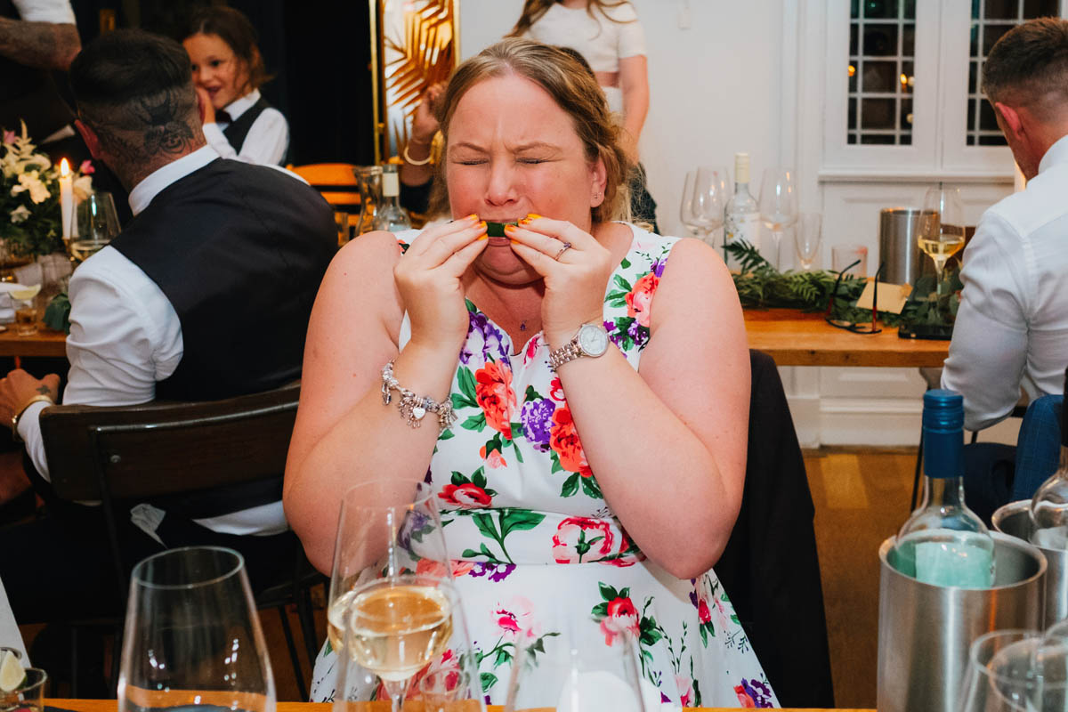 wedding guest sucks lime after tequila shot