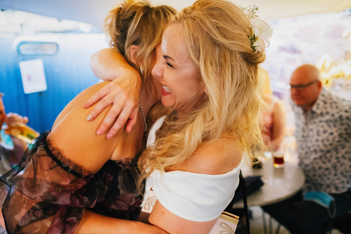 bride hugs her friend at her Bristol wedding