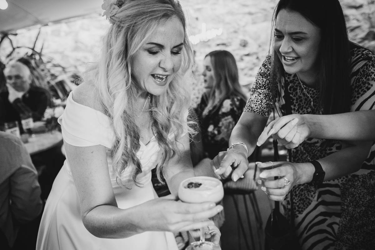 wedding guests encourage bride to drink