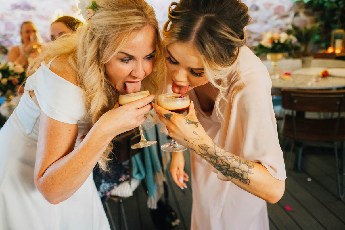 bride and bridesmaid drink espresso martini's on the terrace at the square club wedding venue