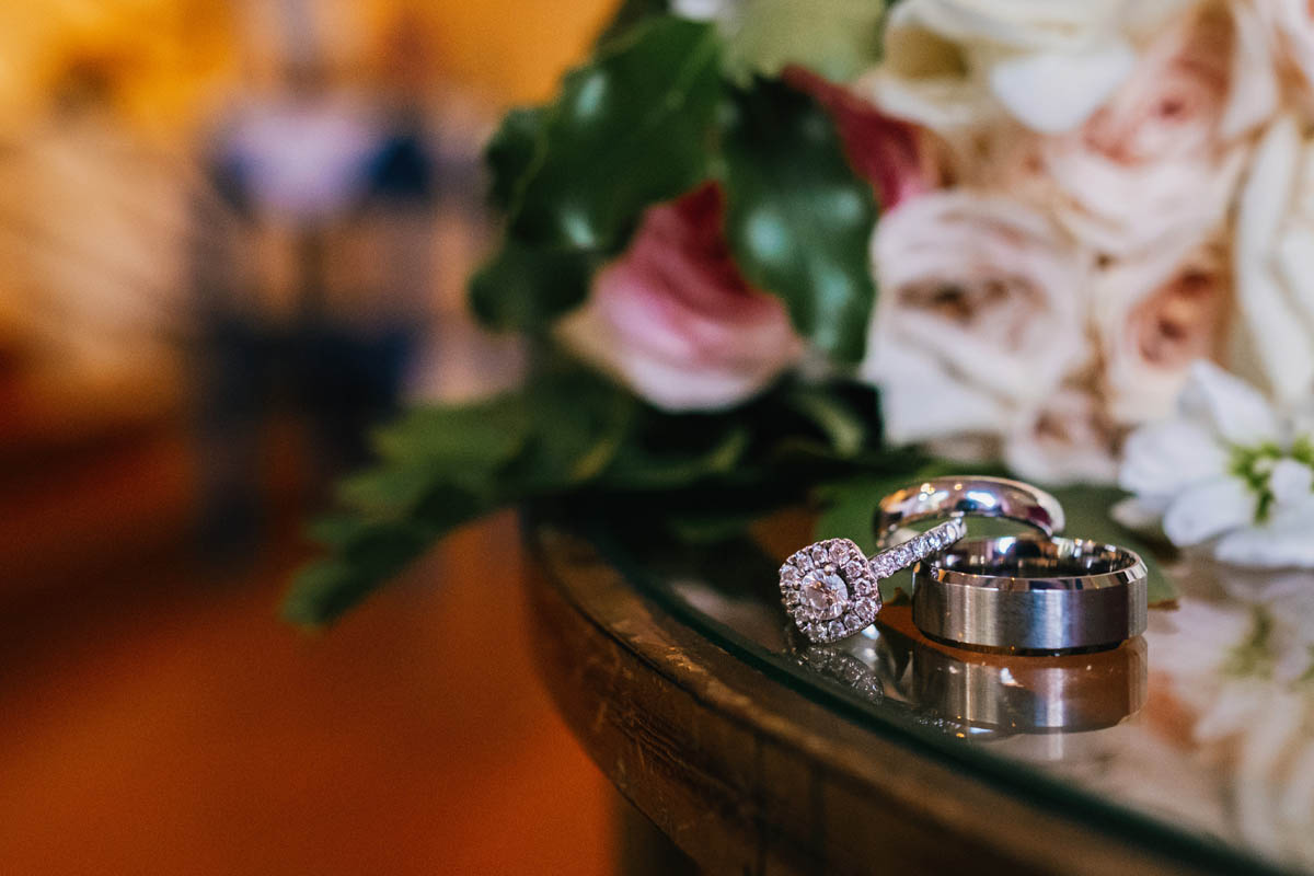 close up shot of wedding and engagement rings