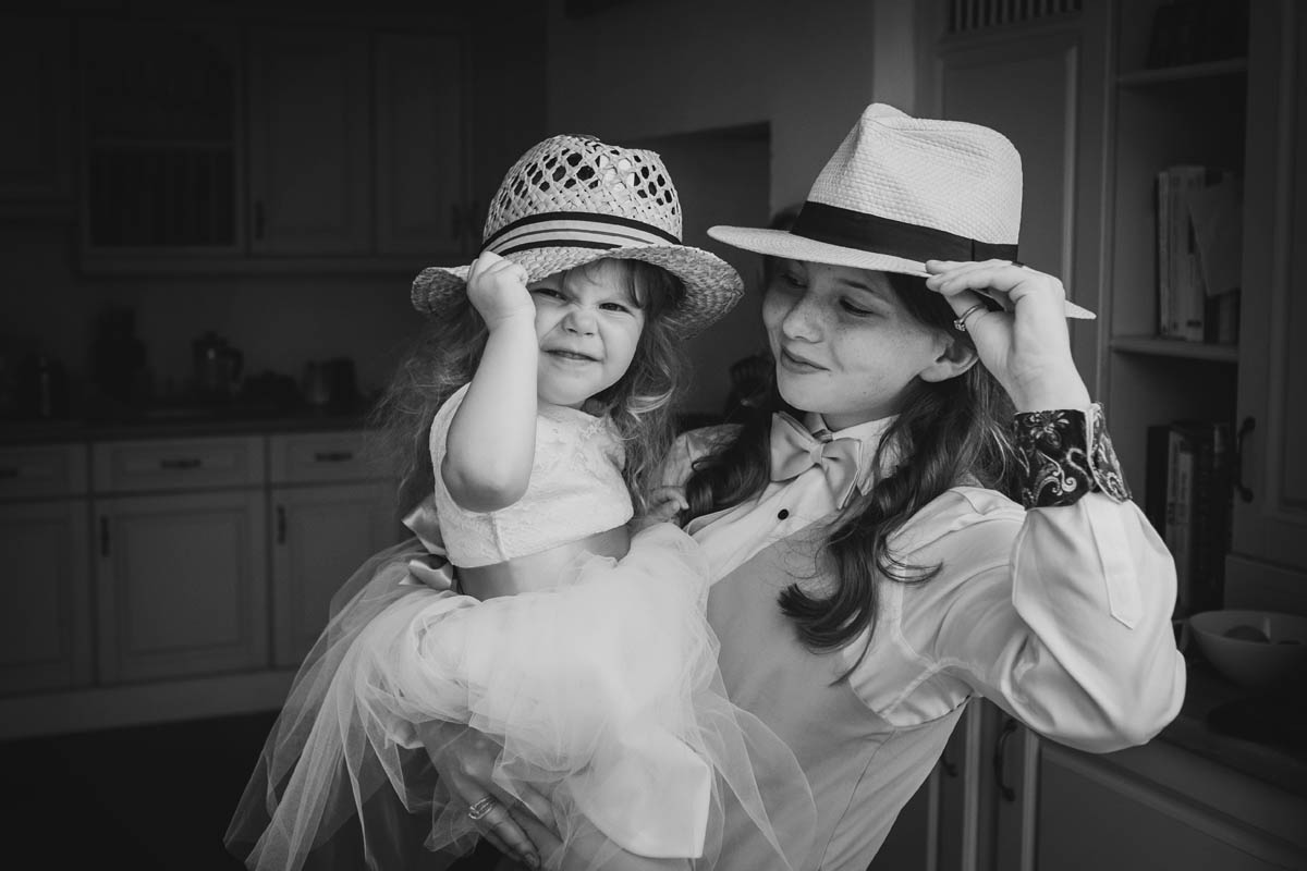 the bride's daughter and granddaughter wearing hats