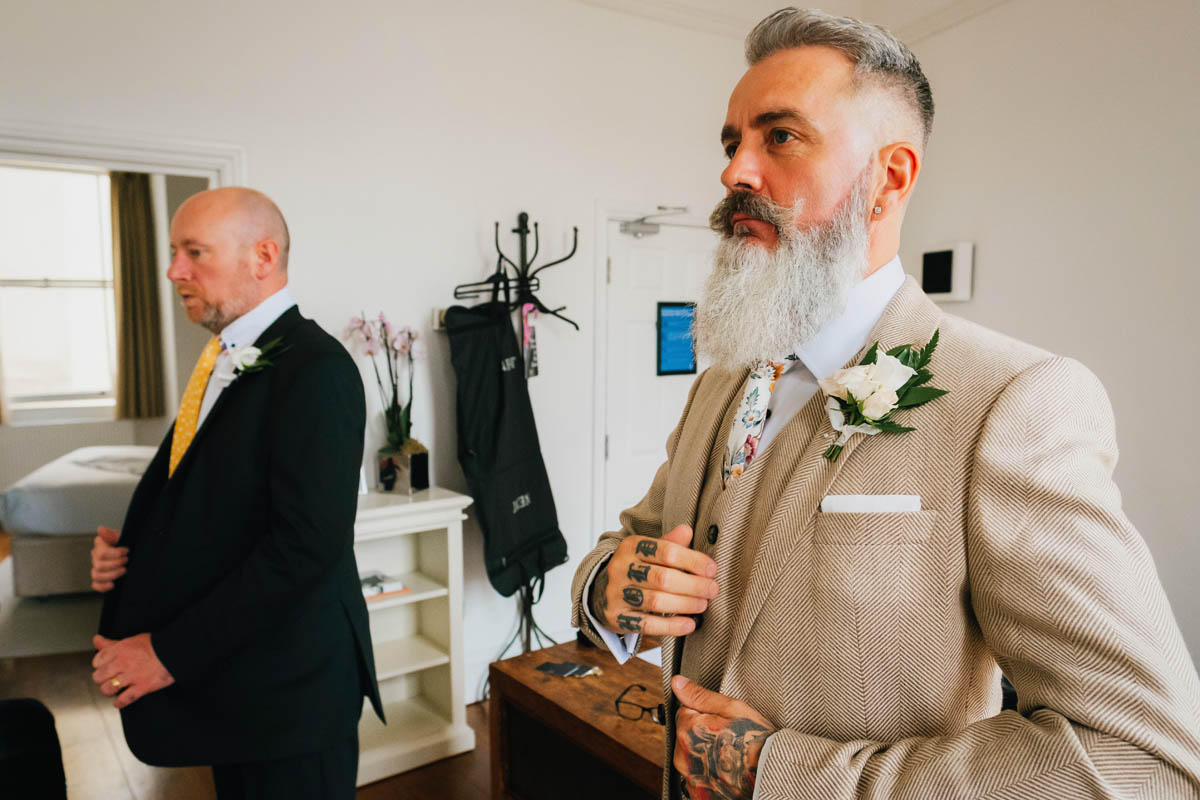 the groom and best man put their morning suits on