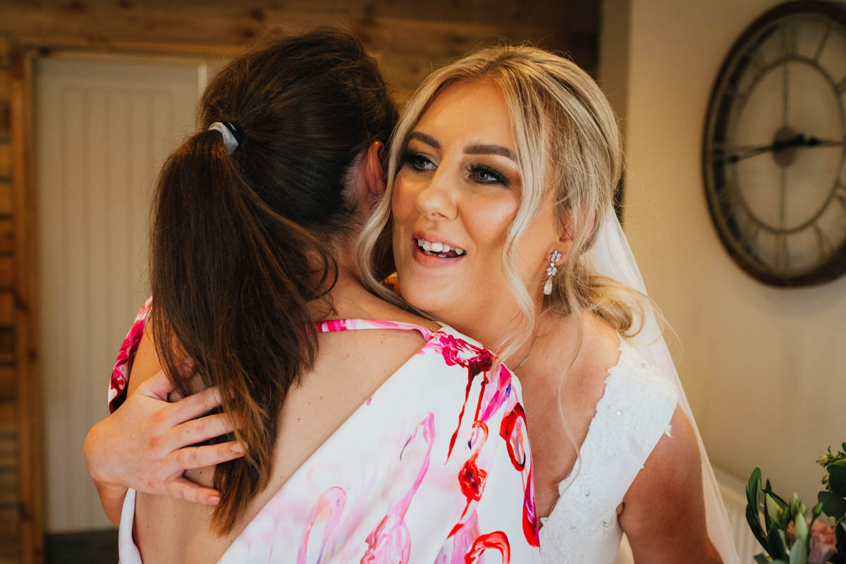a wedding guest congratulates the bride and gives her a hug