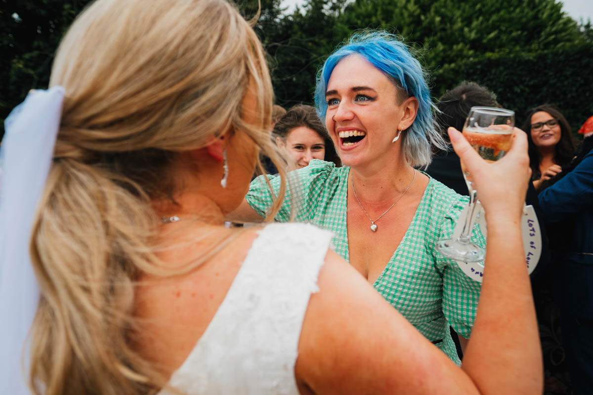 a wedding guest laughs at the bride