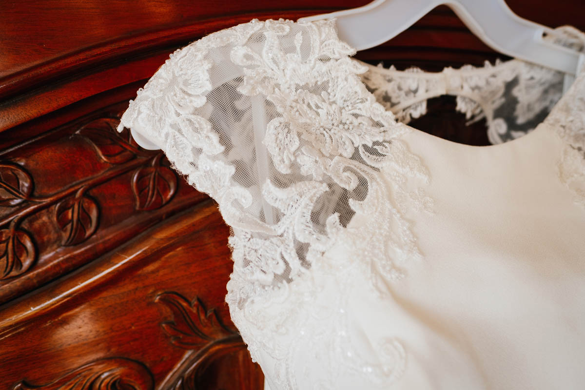 a close up of the ivory lace of the bridal dress' sleeves
