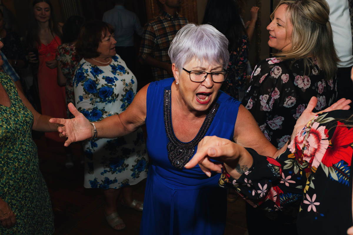 a white lady with grey hair dances on the dancefloor
