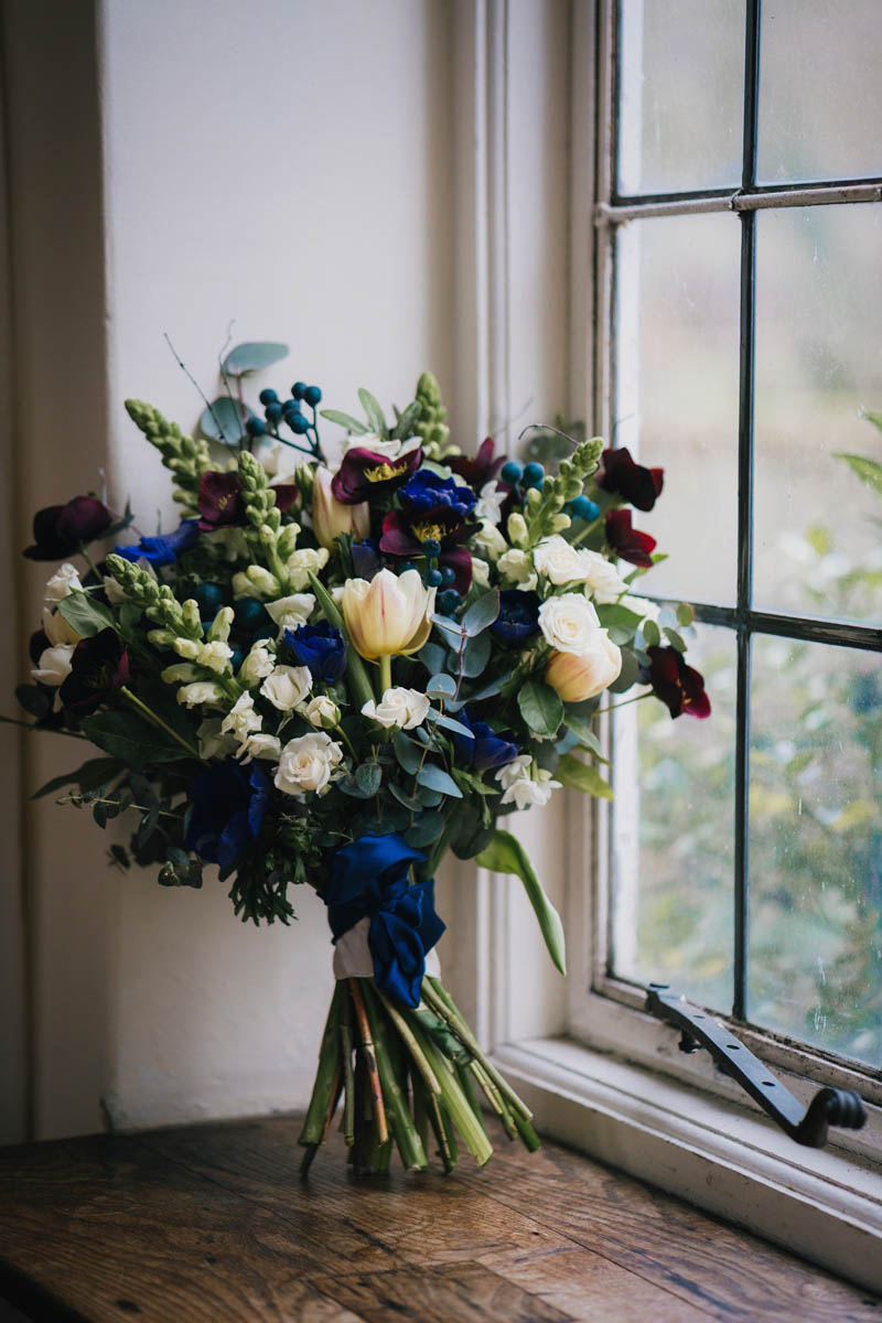 the bride's bouquet with blue ribbon in the window