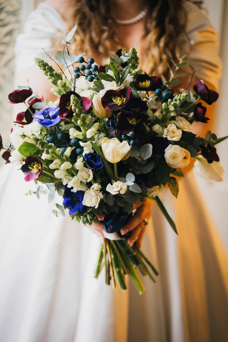 close up of the wedding bouquet which the bride holds out in front of her