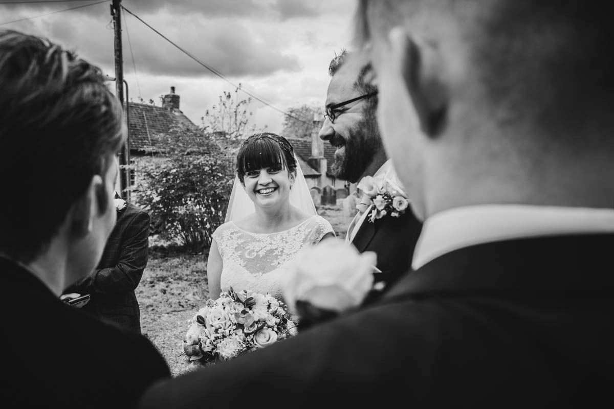 black and white photograph of the bride talking to her wedding guests