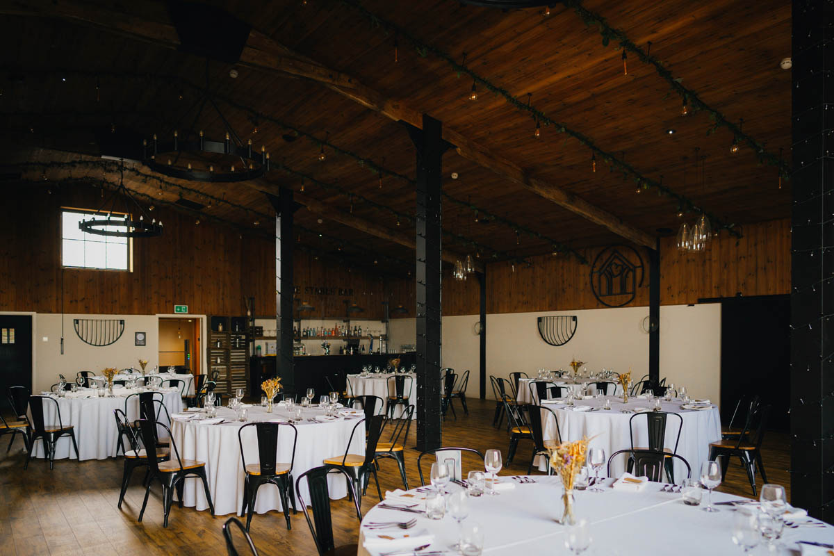 The Stable Barn all set up with tables, chair and decorations ready for the guests to be seated for the wedding breakfast