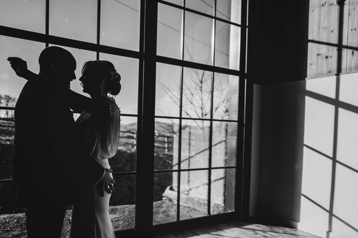 a silhouette photograph of the newly weds inside the big window in the reception room at Upton