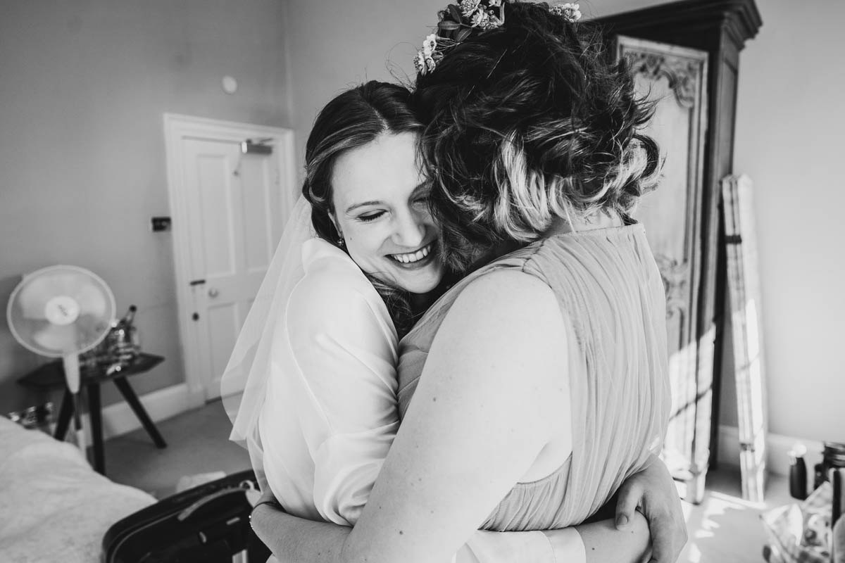 the bride hugs her best friend and maid of honour
