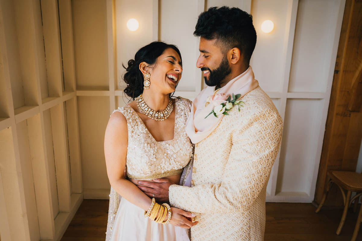 the newly-weds hold each other and laugh