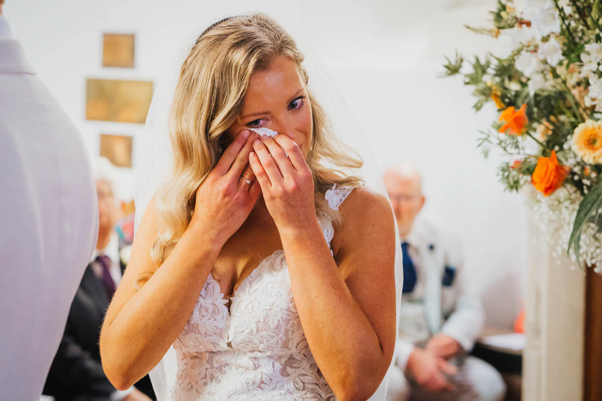 the bride sheds a tear during her wedding ceremony