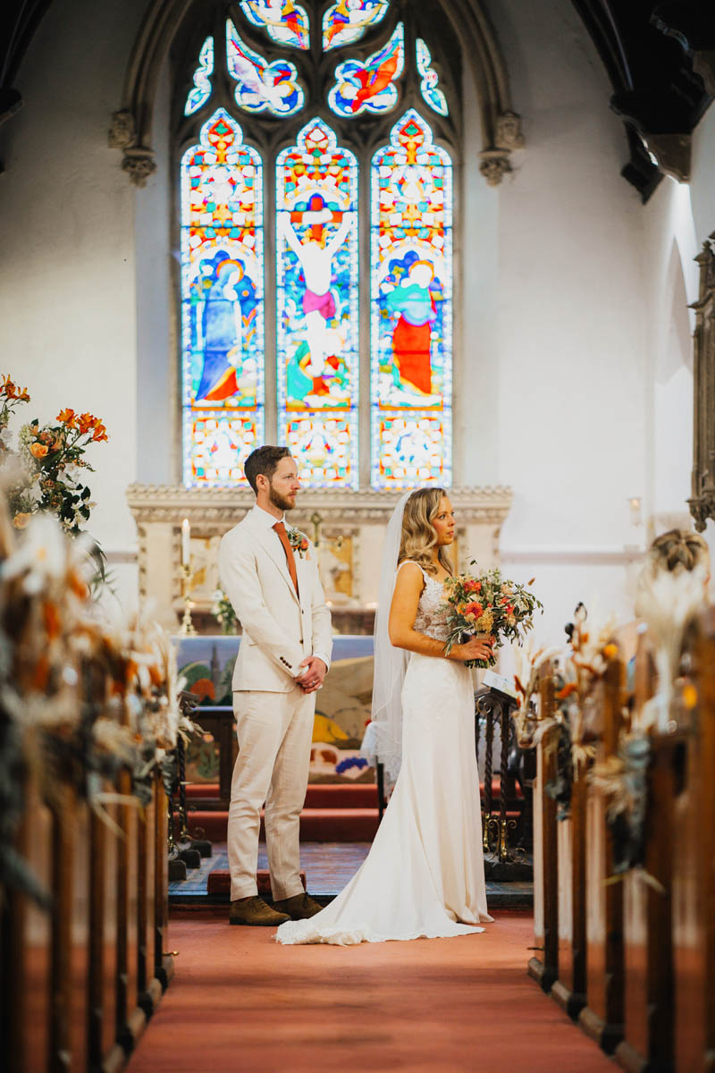 the bride and groom in front of the alter at their wedding ceremony