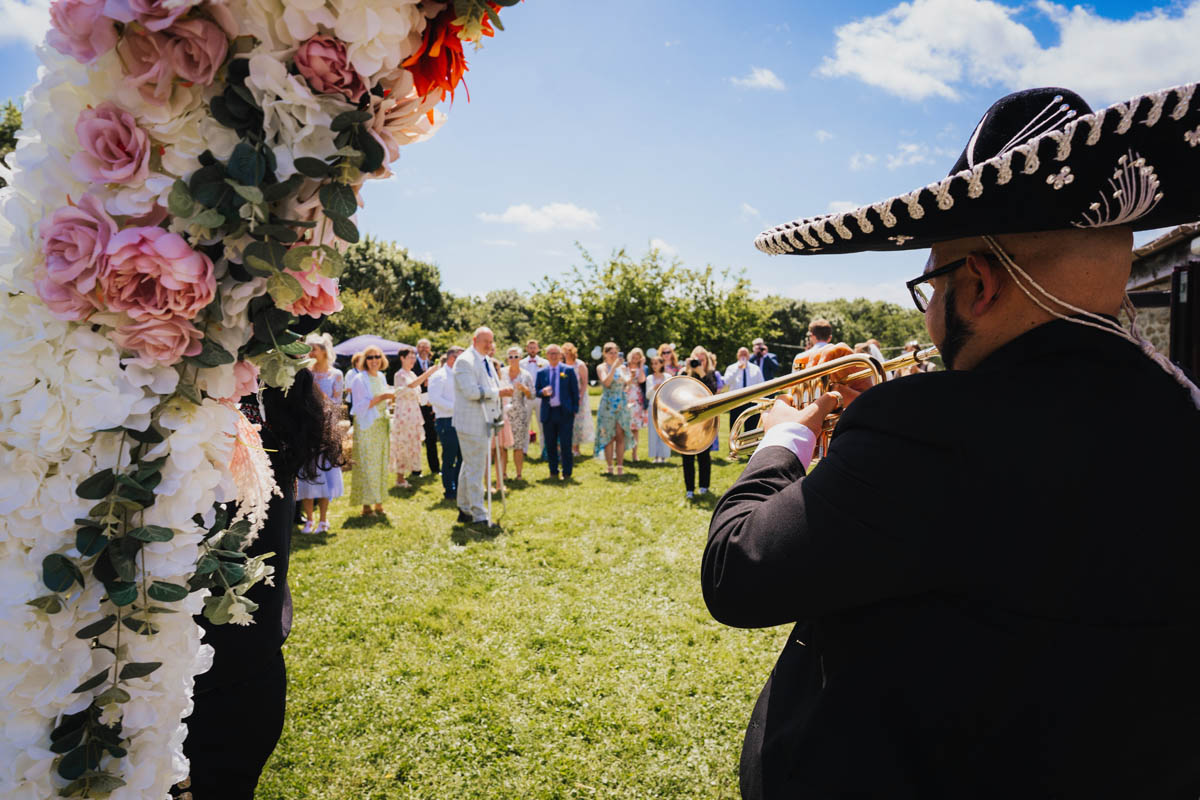a mariachi band plays to wedding guests
