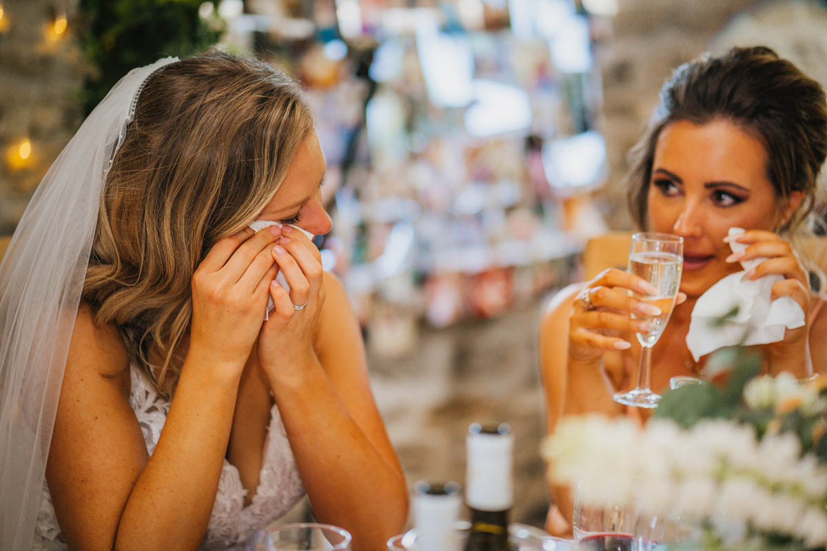 the bride and her bridesmaid shed a tear during the speeches