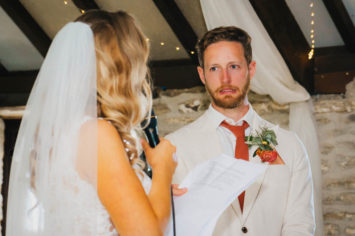 the groom looks concerned at his wife's speech