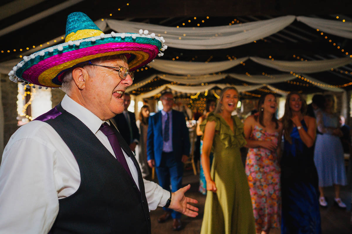 the father of the bride dances in a sombrero