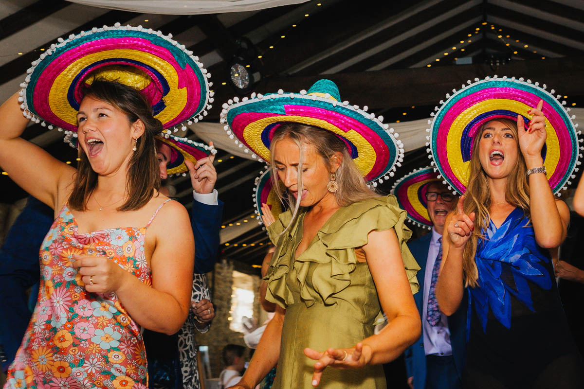 wedding guests dance in sombreros