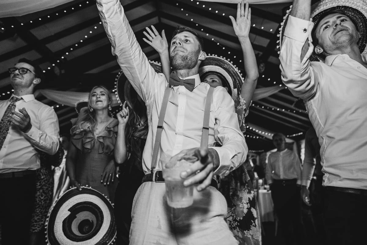 black and white photograph of wedding guests dancing