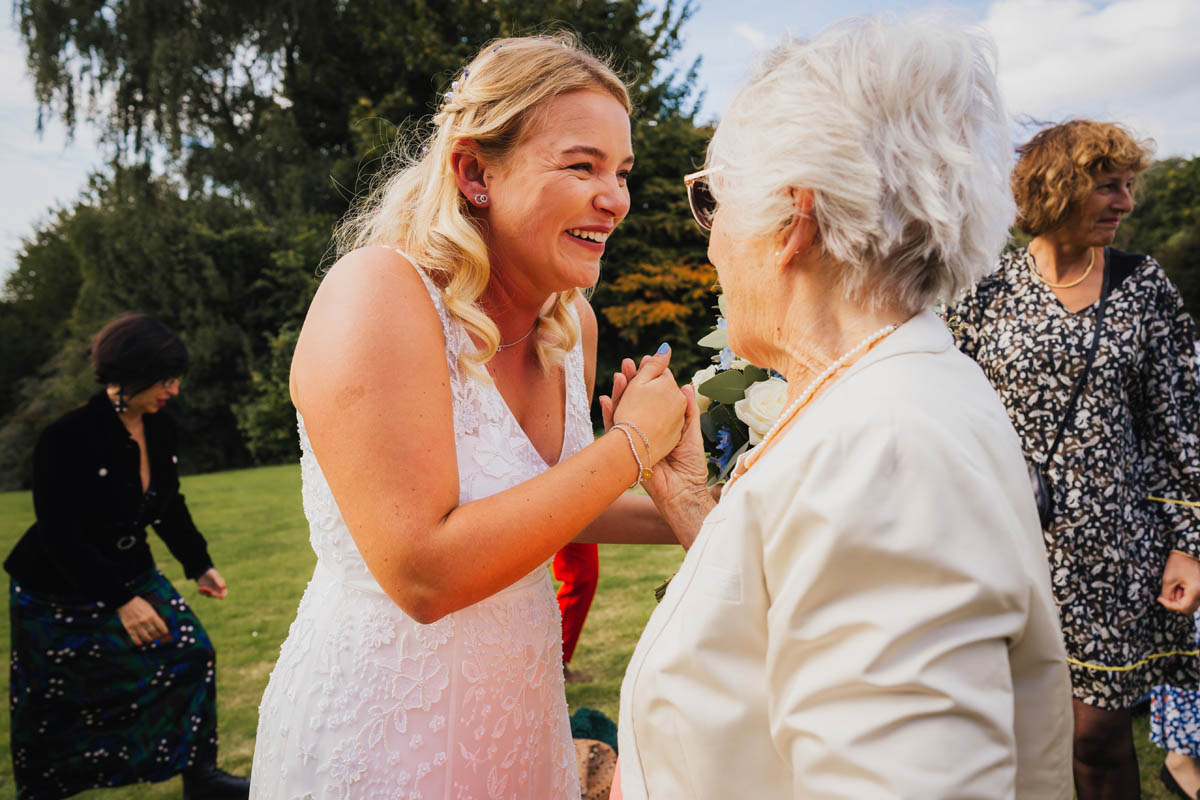 the bride holds her nan's hand as she is overcome with emotion