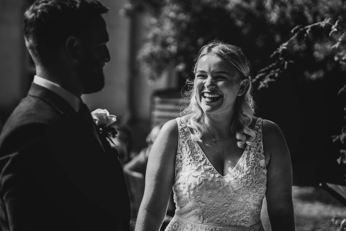 the bride laughs at the groom during the wedding ceremony