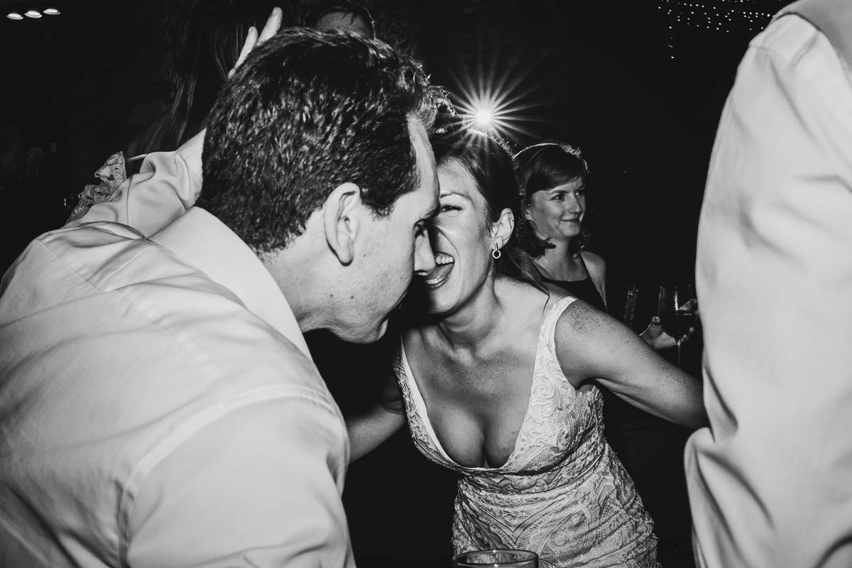 the bride sings with another wedding guests in black and white