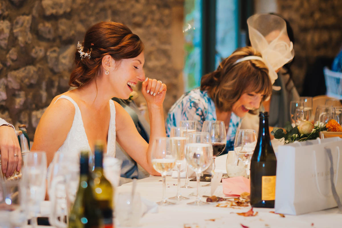 the bride and her mother are bent double laughing at the best man's speech