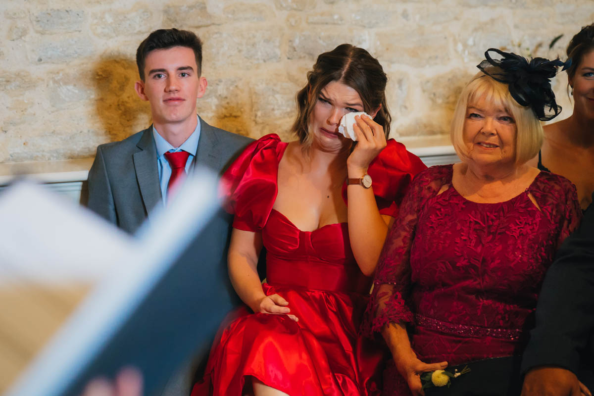 a wedding guest cries during the wedding ceremony