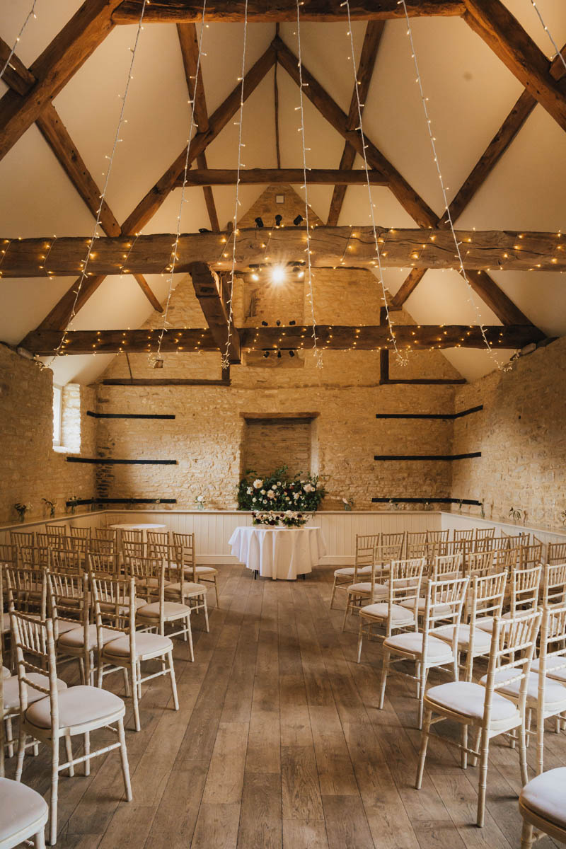 the ceremony room with chairs and fairy lights at wick farm